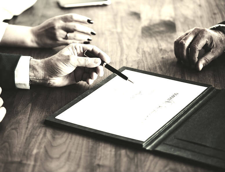 A couple signing divorce papers
