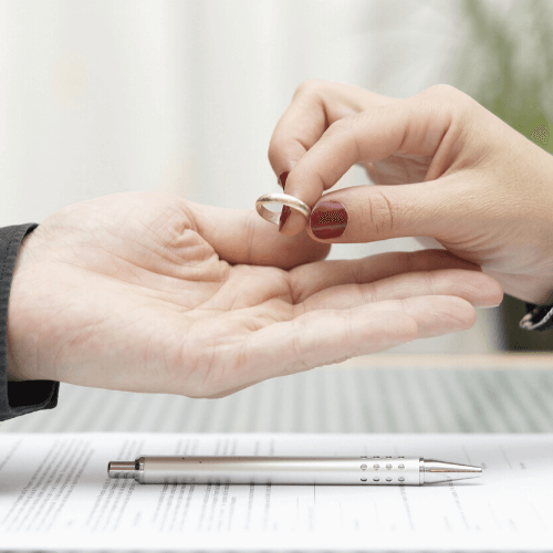 A woman handing a man her ring